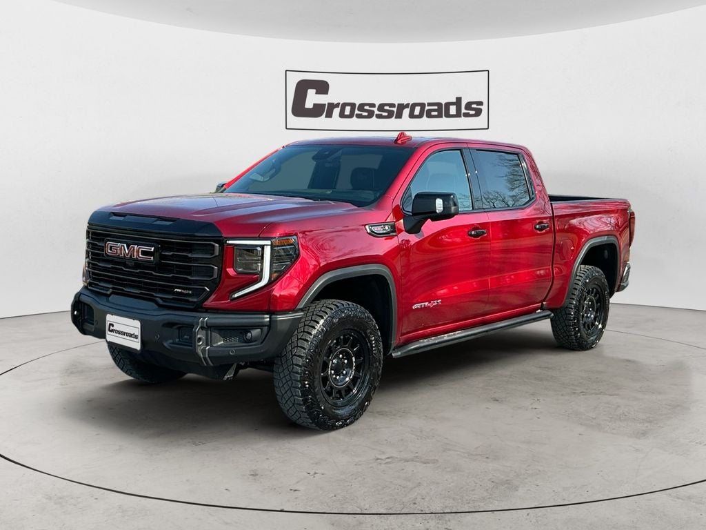 2026 GMC Sierra 1500 AT4X in Volcanic Red Tintcoat — front three-quarter view