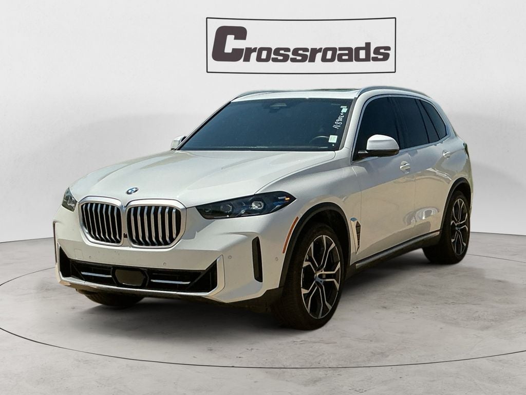2024 BMW X5 xDrive40i in Mineral White Met — front three-quarter view